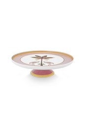 A round pink cake stand with a decorative floral design in the center.