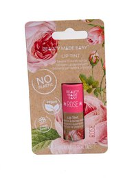 Tinted lip balm in rose color, moisturizing and nourishing formula with natural ingredients.
