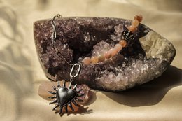  Alix Necklace - Charms: Pendant with natural stone, metal sun charm, and beaded chain.