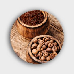 A round wooden wall decor featuring coffee beans in wooden bowls.