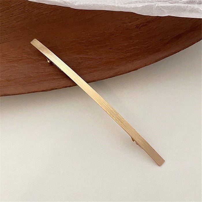 Minimalistyczna, jednoliniowa metalowa spinka do włosów