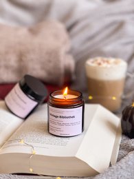  Vintage-inspired scented candle in a glass container, with a warm amber glow and cozy, relaxing atmosphere.