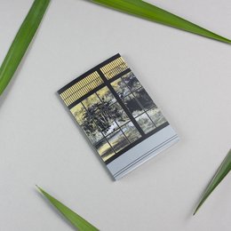 A6 notebook with a Shoji Marianne design featuring a black and white landscape image with vertical lines and a pen.