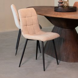 Beige boucle dining chair with black metal legs, quilted backrest, modern minimalist style.