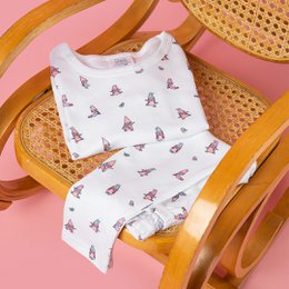 White children's pajamas with a repeating pattern of colorful gnome illustrations. The pajamas are made of soft, comfortable material and are suitable for ages 1-6 years.