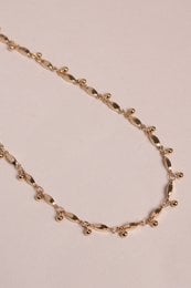 Gold-toned chain necklace with delicate links and a simple, elegant design.