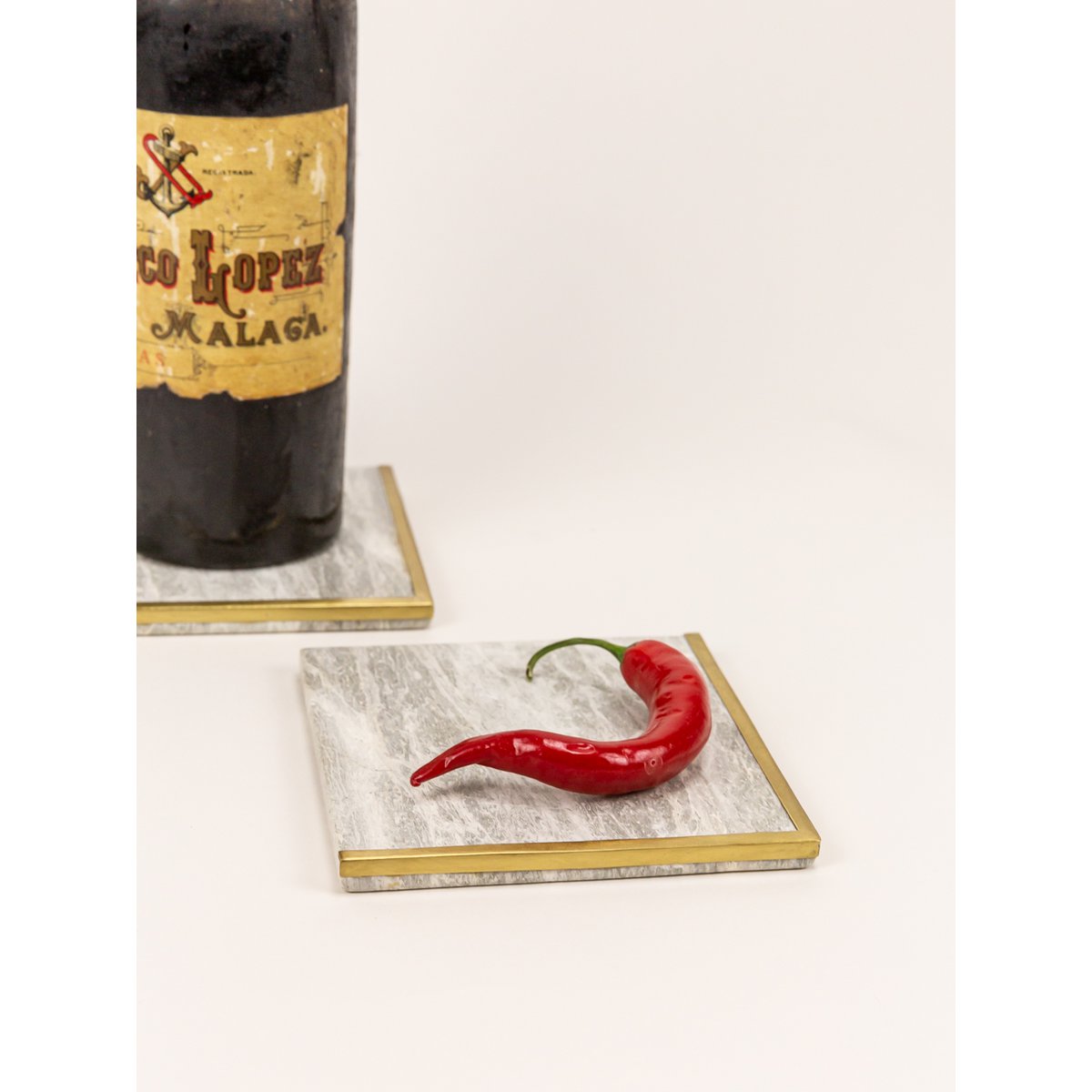 Square natural stone bottle coaster with half edges in brass