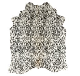 Zebra stripe animal print cowhide rug, black white pattern, large floor covering, natural texture.