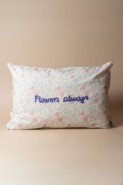 Floral patterned cushion with "Flowers always" text, multicolor flowers, soft pastel design, decorative pillow