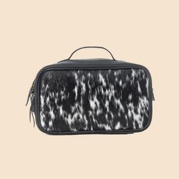  Black and white patterned toiletry bag with a handle and multiple zippered compartments.
