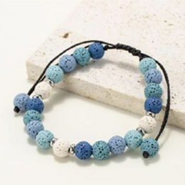 Round beaded bracelet made of natural lava stone in shades of blue and white.