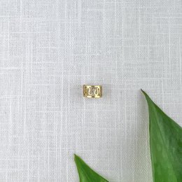 Elegant gold-tone ear cuff with a delicate, balanced design. Suitable for casual or formal wear.