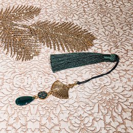  Colorful, decorative bookmarks with tassels, sequins, and floral elements. The bookmarks feature a variety of colors including red, yellow, and purple, and incorporate natural materials like flowers and beads.