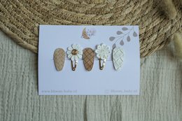 A set of colorful hair clips for kids, featuring various shapes and designs such as leaves, flowers, and insects.
