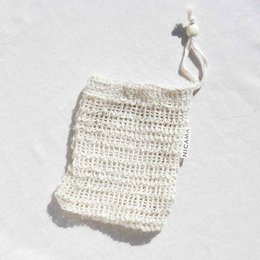 Handmade natural sisal soap bag, beige color, textured crochet pattern, suitable for storing and displaying bar soap.