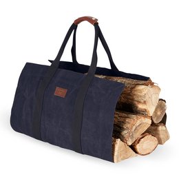 Navy blue canvas log bag with leather accents, suitable for storing and transporting firewood.