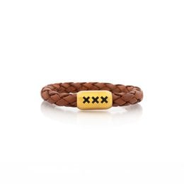 Leather bracelet in light brown color with braided design and metal accent. Available in multiple sizes and colors including black, silver, and gold.