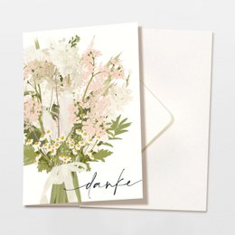 Folded thank you card with envelope featuring a bouquet of pink flowers and a bow, made from FSC certified materials.