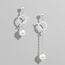 Elegant asymmetrical 925 sterling silver earrings with freshwater pearls, perfect for formal or casual wear.