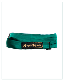 Green fabric bow tie with wooden bow accent, featuring the Mountain Feather logo.