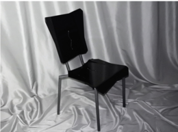 Black modern chair with abstract shapes, representing uniqueness.
