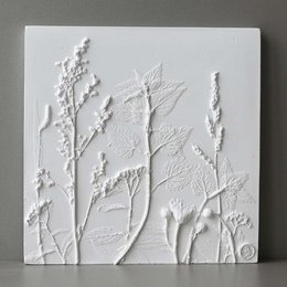 Textured white relief mural with abstract plant-like shapes, suitable for home decor.