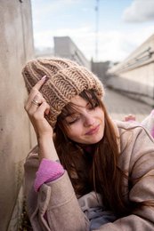 Beige knitted hat for children and adults, featuring a cozy and warm design.