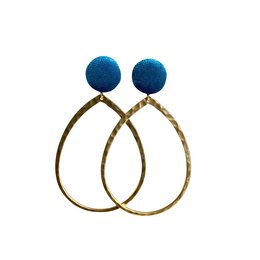 Elegant blue stud earrings with gold-tone hoops. The earrings feature a round blue fabric-covered stud attached to a large open hoop design, creating a modern and stylish look.