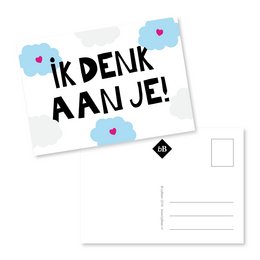 A postcard with the text "Ik denk aan je!" (I'm thinking of you!) written in a handwritten style. The postcard has a simple, minimalist design with a white background, blue clouds, and a small heart icon.