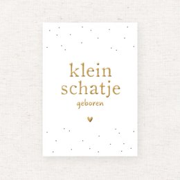 A white card with gold foil text that reads "klein schatie geboren" (Dutch for "little treasure born"). The card has a simple, minimalist design with small gold dots or stars in the background.