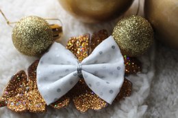 Silver polka dot Christmas barrette with glittery gold accents, perfect for festive holiday hairstyles.