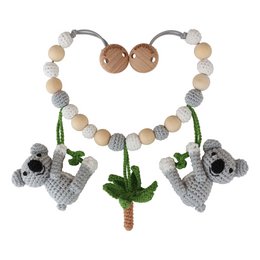 Crocheted stroller chain with koala and cactus charms in neutral colors.
The crocheted stroller chain features two koala charms and a cactus charm in neutral tones of beige, gray, and green. The charms are made of crocheted yarn and attached to a chain with wooden beads. This accessory is suitable for prams and strollers, providing a decorative and tactile element for babies and young children.