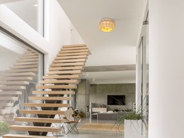  Ceiling lamp with a round, woven rattan shade and a warm, yellow-toned light source.
