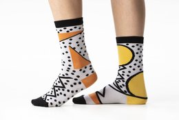 Graphic oversized organic cotton socks with a bold, abstract pattern featuring polka dots, geometric shapes, and contrasting colors.
