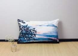 Rectangular cushion with a scenic landscape design featuring palm trees and a blue sky.