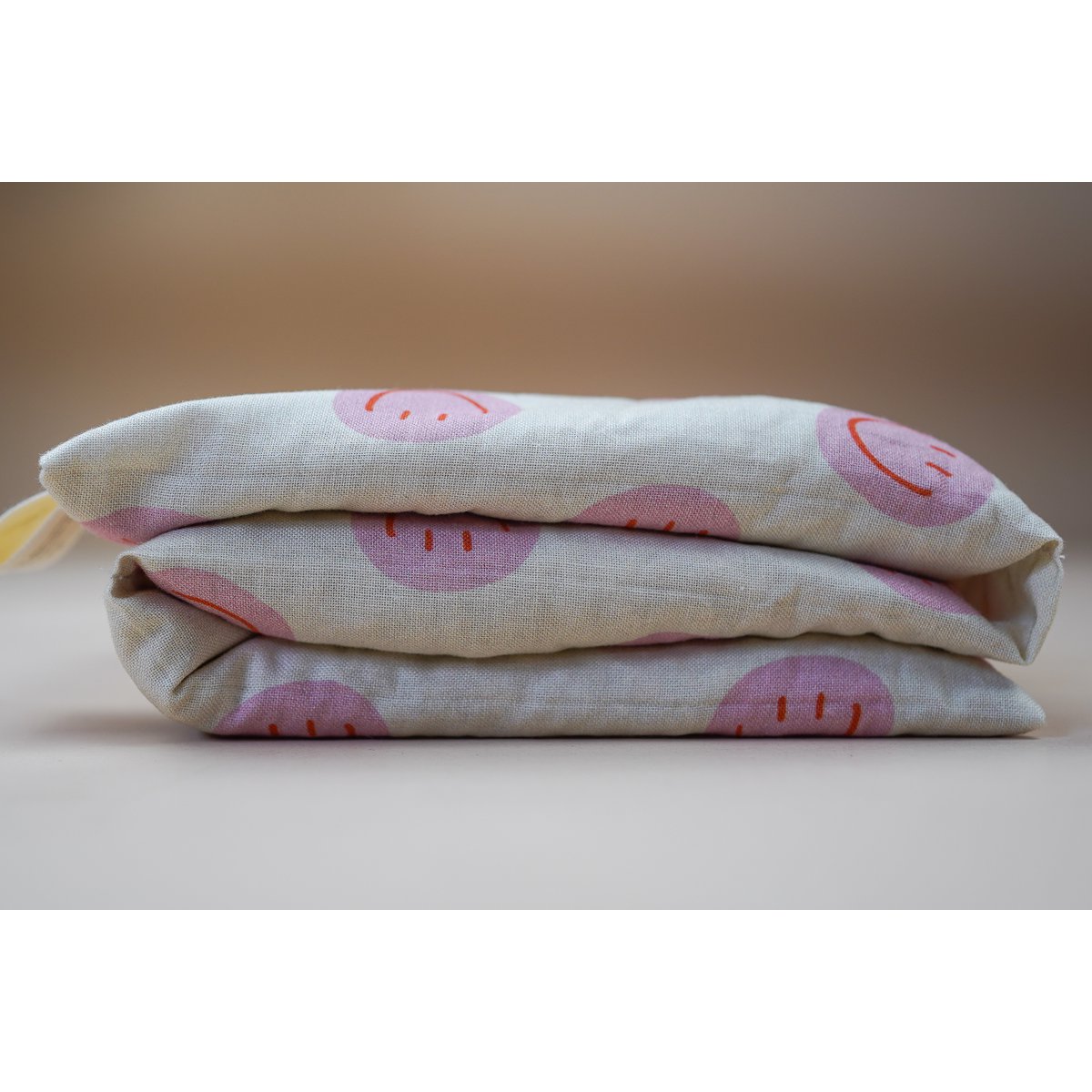 Katoenen warmtekussen gevuld met biologische spelt Smiley Pink