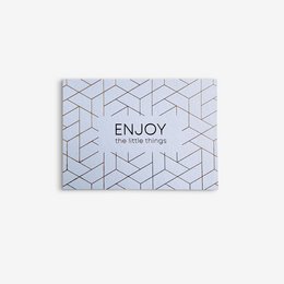 Postcard with the text "ENJOY the little things" and a geometric pattern design in gold and white.