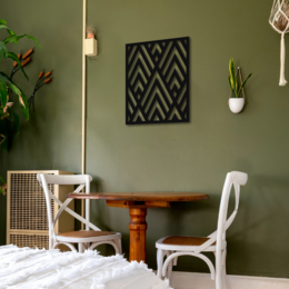 Angles Metal Wall Art by Jacques, a modern and geometric wall decor piece with a black and white chevron pattern, available in multiple sizes to suit different spaces.