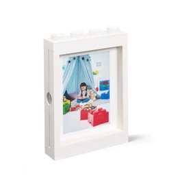 White wooden photo frame with a picture of a child playing with Lego blocks inside.