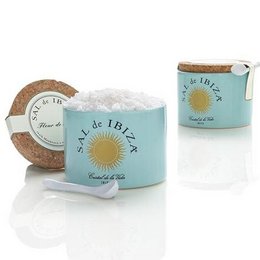 Ceramic pot containing Fleur de Sel salt from Ibiza, Spain. Includes a wooden spoon for serving. Packaged in a decorative tin with the Sal de Ibiza logo.