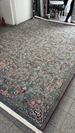 Large dark blue area rug with intricate floral and geometric patterns, suitable for living rooms or bedrooms.