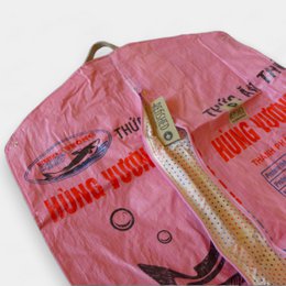 Environmentally friendly clothing bag in a light pink color, with a zipper closure and handles. The bag features the text "Hung Hom" printed on it.