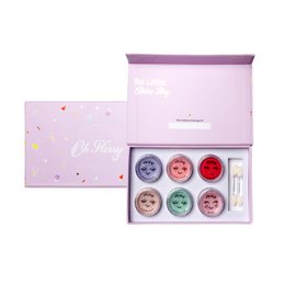 Pastel pink makeup set with six colorful eyeshadow pots, sweet treat themed cosmetics collection.