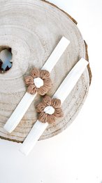 A delicate baby hair band with two small flower accessories in a neutral color palette, suitable for infants and young children.