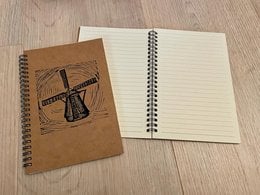 Windmill-themed notebook with blank or lined pages, featuring a windmill and floral design on the cover.