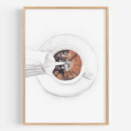 A framed fine art print featuring a close-up view of a coffee cup with milk swirls. The image captures the intricate patterns and textures of the coffee and milk, creating a visually appealing and artistic representation of a simple everyday moment.