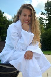 A soft, plush bathrobe with a shawl collar in a variety of colors and sizes, perfect for relaxing at home or after a bath.