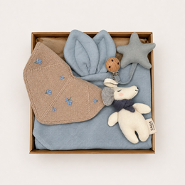 Soft, delicate baby gift set in mellow rose color. Includes a bib, blanket, and swaddle wrap with subtle embroidered details. Perfect for a newborn or baby shower.
