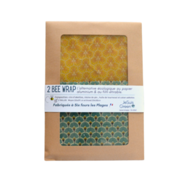 Two reusable beeswax food wraps in a variety of yellow and green patterns, suitable for covering and storing food items.