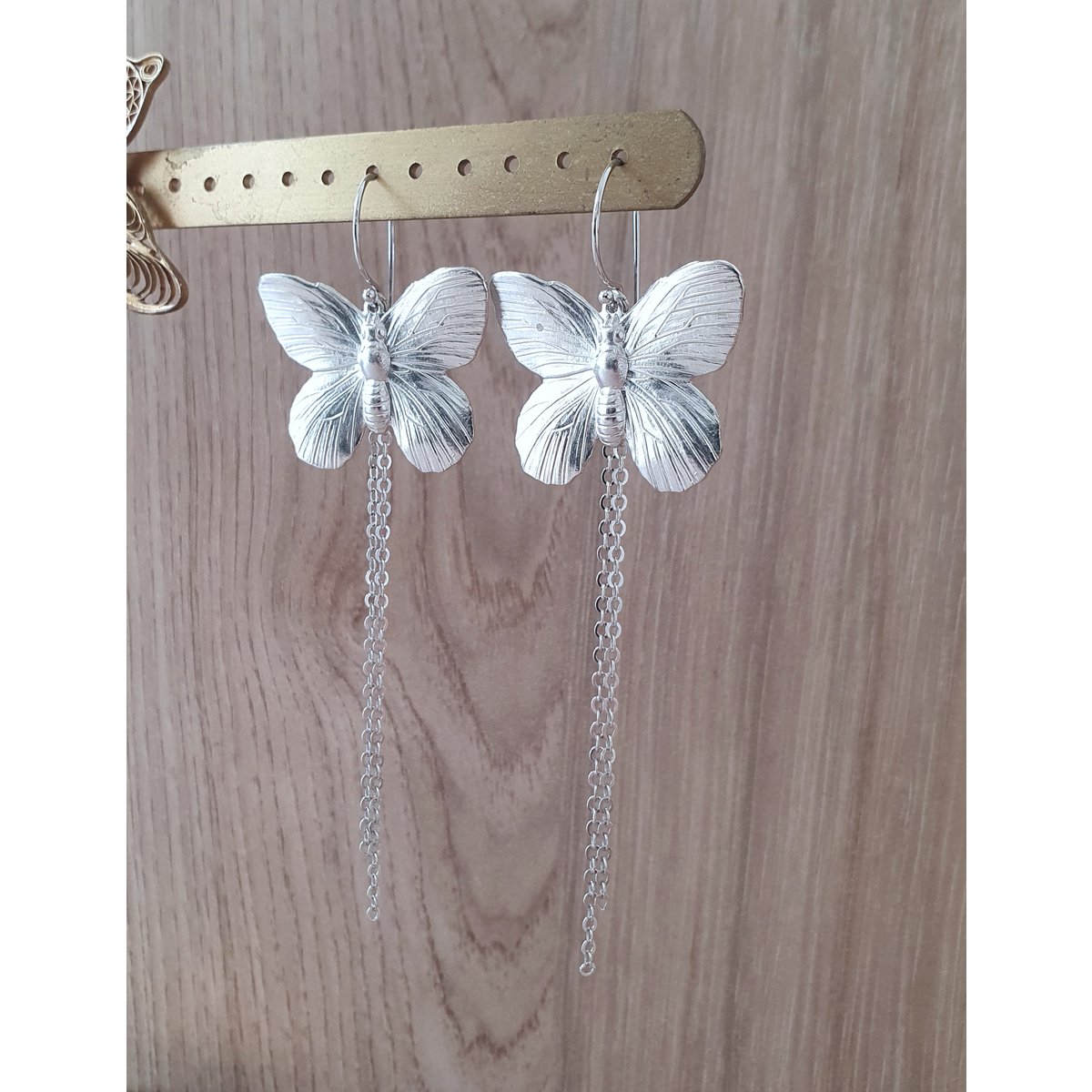 Long-length rhodium plated butterfly earrings